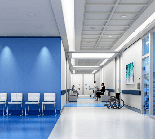 Modern hospital corridor with seating and wheelchair.