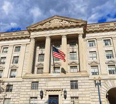 Historic building with American flag and columns.